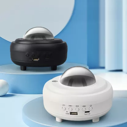 White and black versions of the Northern Lights Moon Lamp displayed on podium – stylish and modern lighting decor