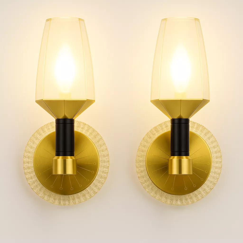 Modern gold and black crystal wall sconces with amber glow, mounted on white wall