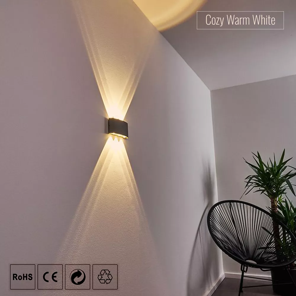 Black LED wall sconce with warm up and down lighting installed in living room corner for decorative interior lighting