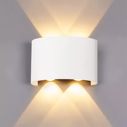 Modern LED up and down wall light showing dimensions 12cm width and 9.5cm height with warm lighting effect