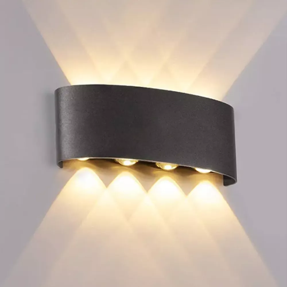 Black LED wall light with up and down illumination mounted indoors for modern bedroom and living room wall lighting