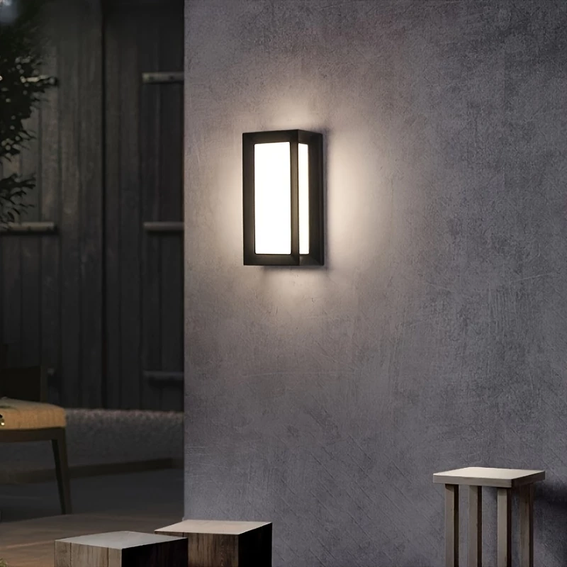 Waterproof aluminum outdoor wall lamp lighting a patio seating area at night