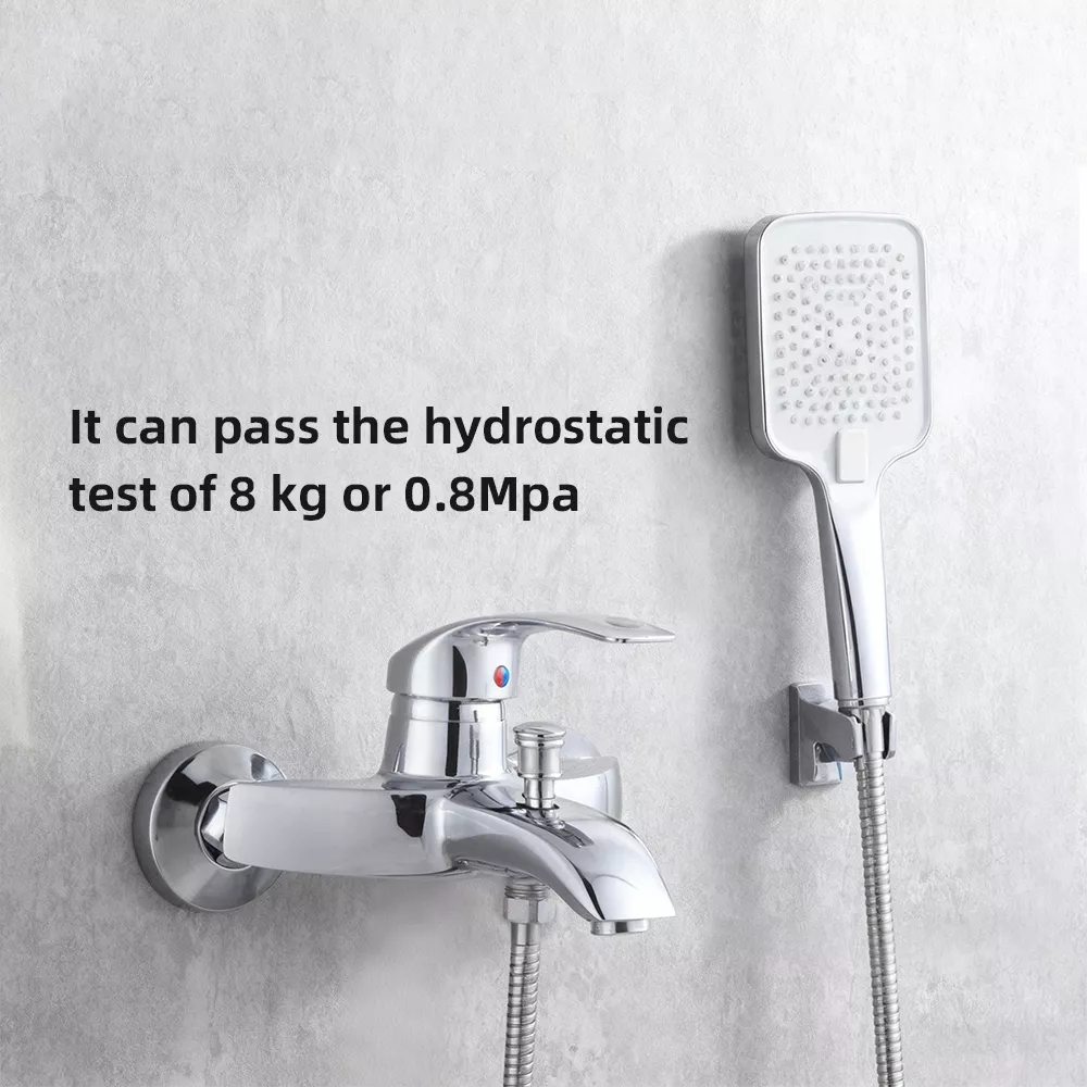 Chrome wall-mounted bathtub faucet connected to a 1.5-meter stainless steel flexible shower hose in a modern white bathroom.