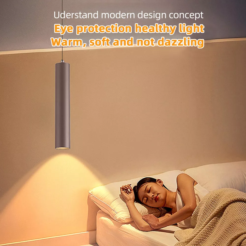 Warm soft LED pendant light installed above bedside table, eye-protection hanging lamp for bedroom with non-dazzling ambient lighting.