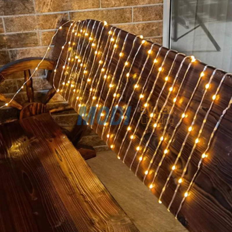 Warm white string lights draped over a wooden bench for outdoor decoration